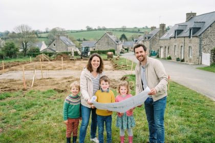 Famille souriante devant le chantier en Bretagne